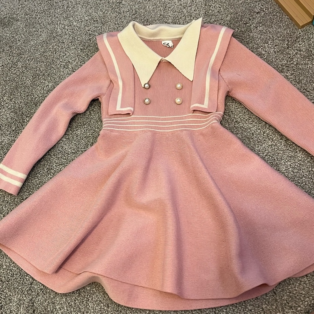 Cute pink and white sweater dress with half pearl buttons sewn on front. Size 4t
